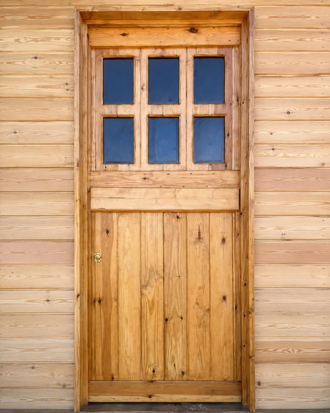 Handmade glazed pine stable door with six panes and a brass handle