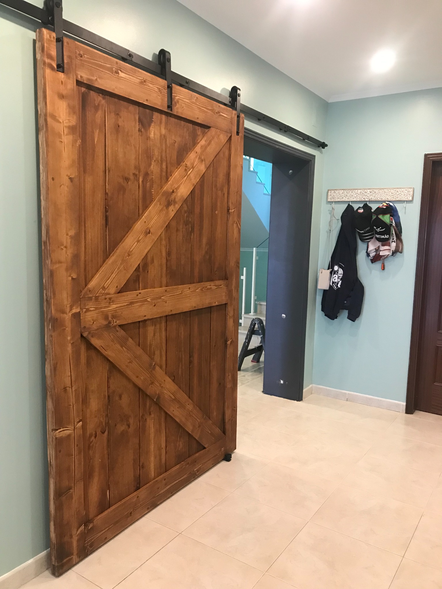 Angled view of an oversized handmade timber sliding door standing open